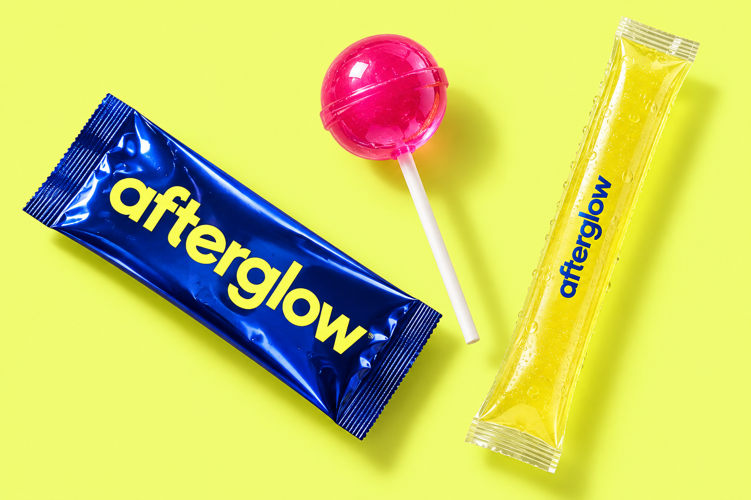 Afterglow packaging concepts: a blue powder sachet, pink lollipop, and yellow freezer-pop tube